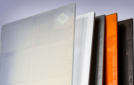 Teknor Apex Plaques that showcase Crealen R PP compounds that re colored white, orange, black and gray. 