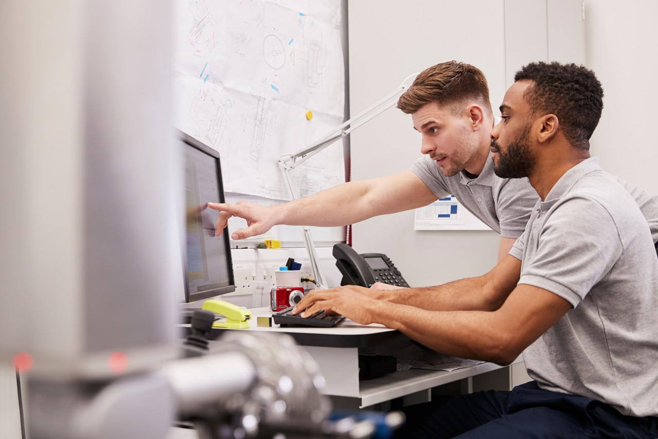 Male Engineers Use CMM Coordinate Measuring Machine In Factory