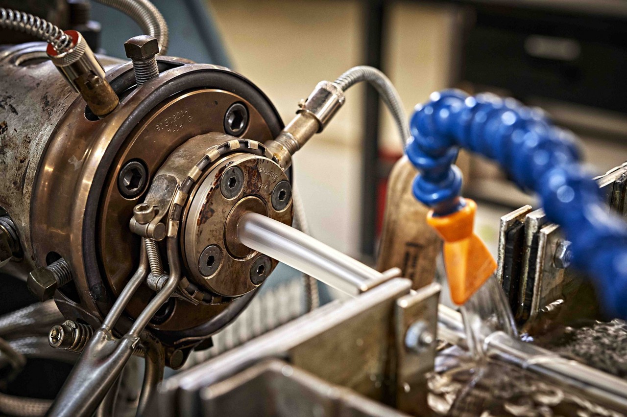Extrusion machine extruding soft matte PVC medical tube close up